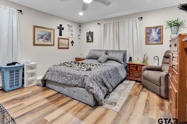 a bedroom with a bed couch and a window