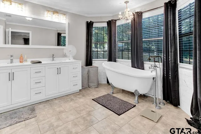 a spacious bathroom with a shower sink and mirror
