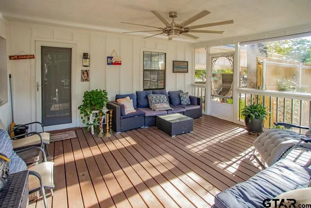 a balcony with couch and large windows
