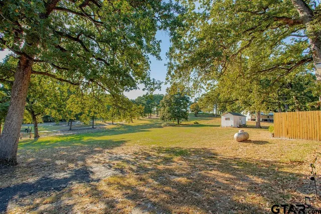 a view of a fountain in middle of the middle of a yard