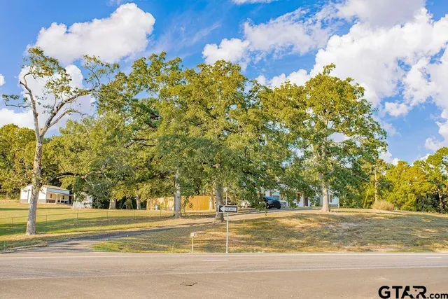 a view of a swimming pool and a yard