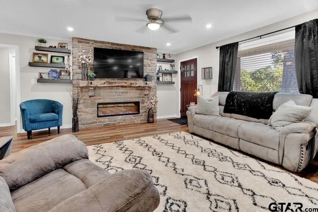a living room with furniture and a flat screen tv