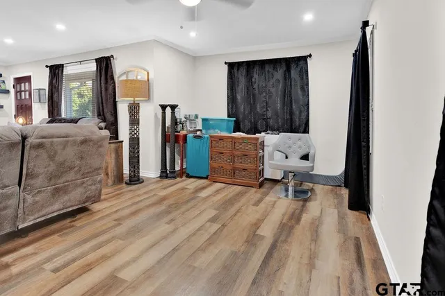a living room with furniture and a wooden floor