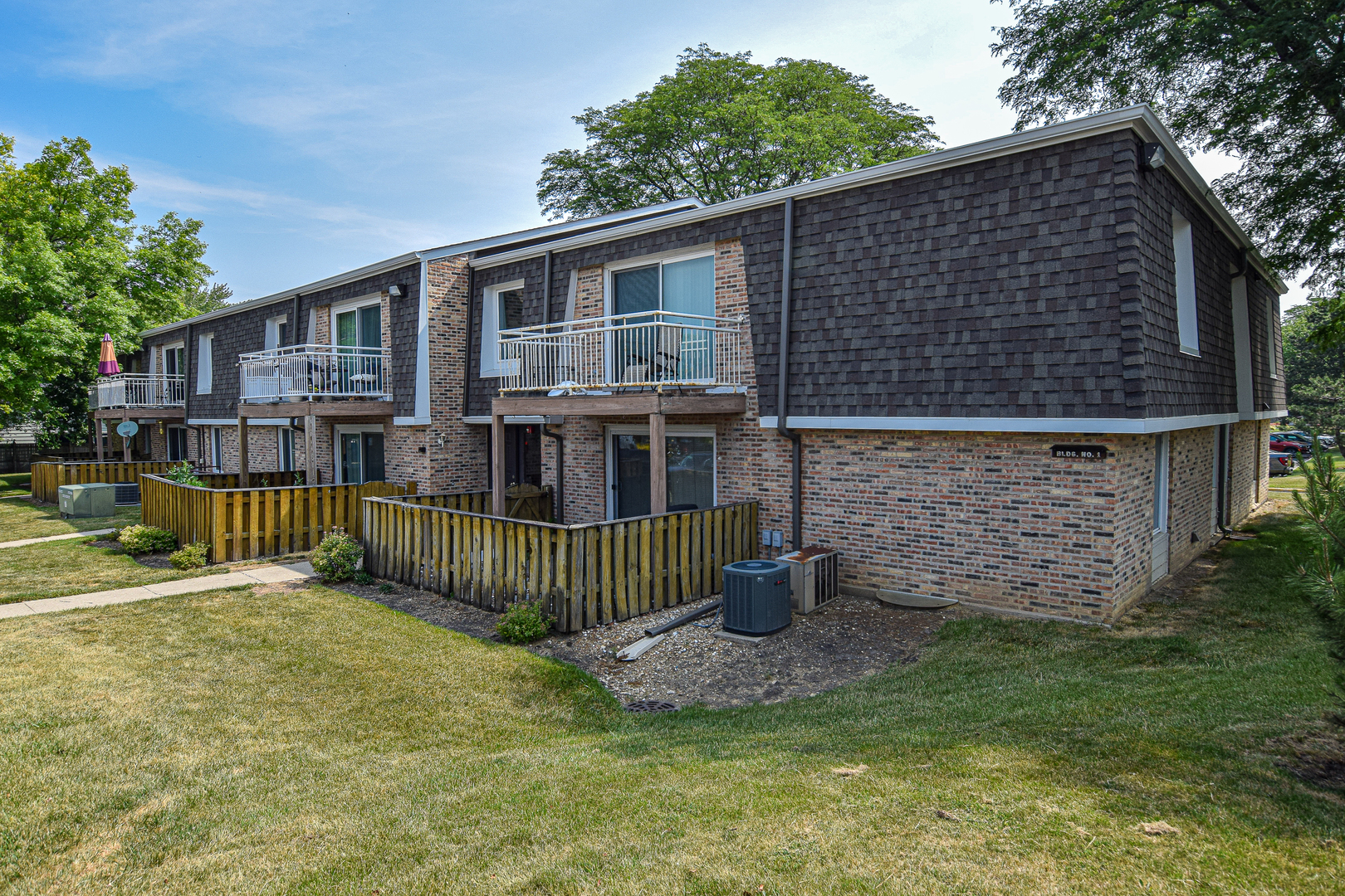 1802 Plum Grove Road, Unit 2A Rolling Meadows, IL 60008 - Photo 1 of 19 a front view of a house with a garden
