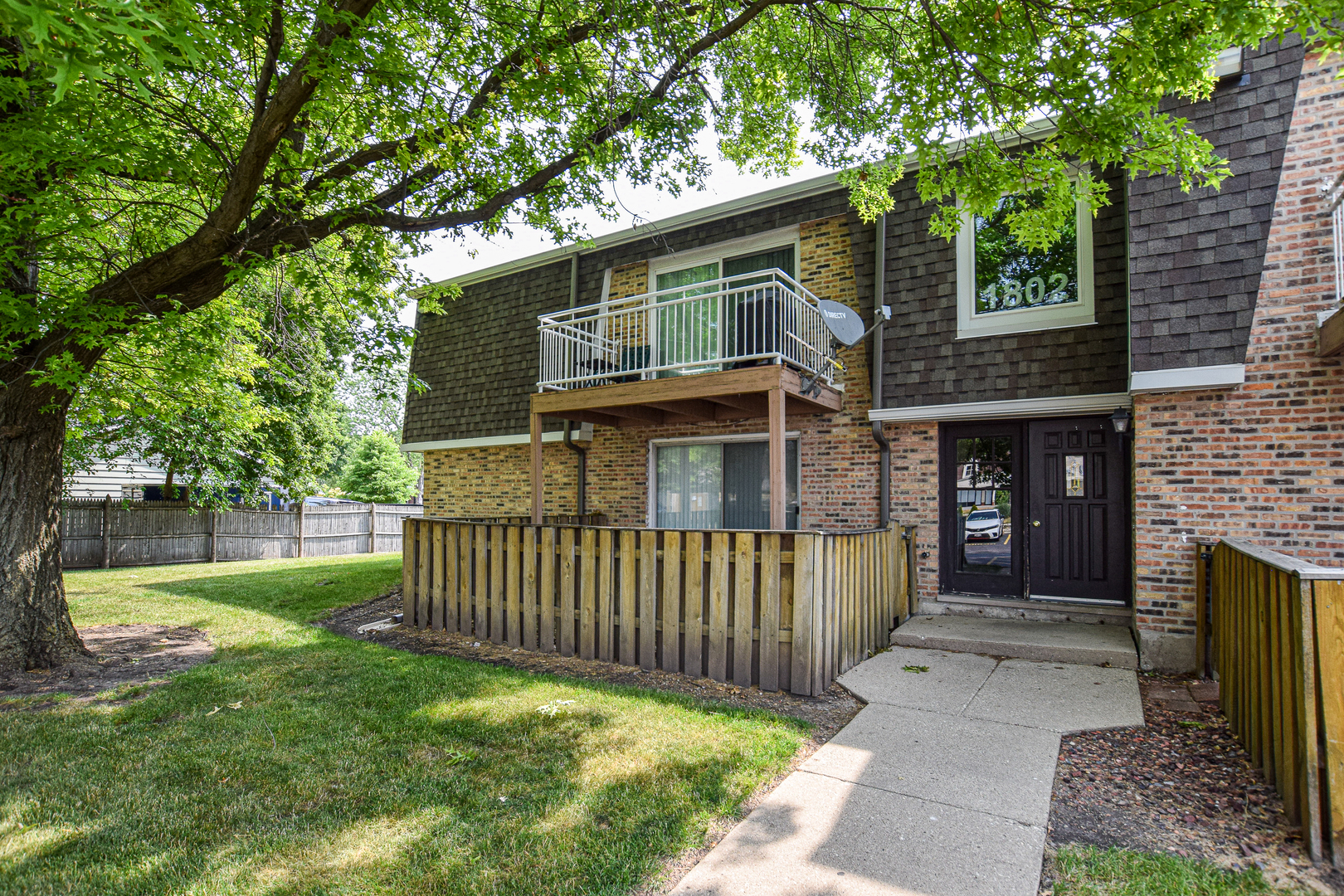 1802 Plum Grove Road, Unit 2A Rolling Meadows, IL 60008 - Photo 2 of 19 a front view of a house with garden