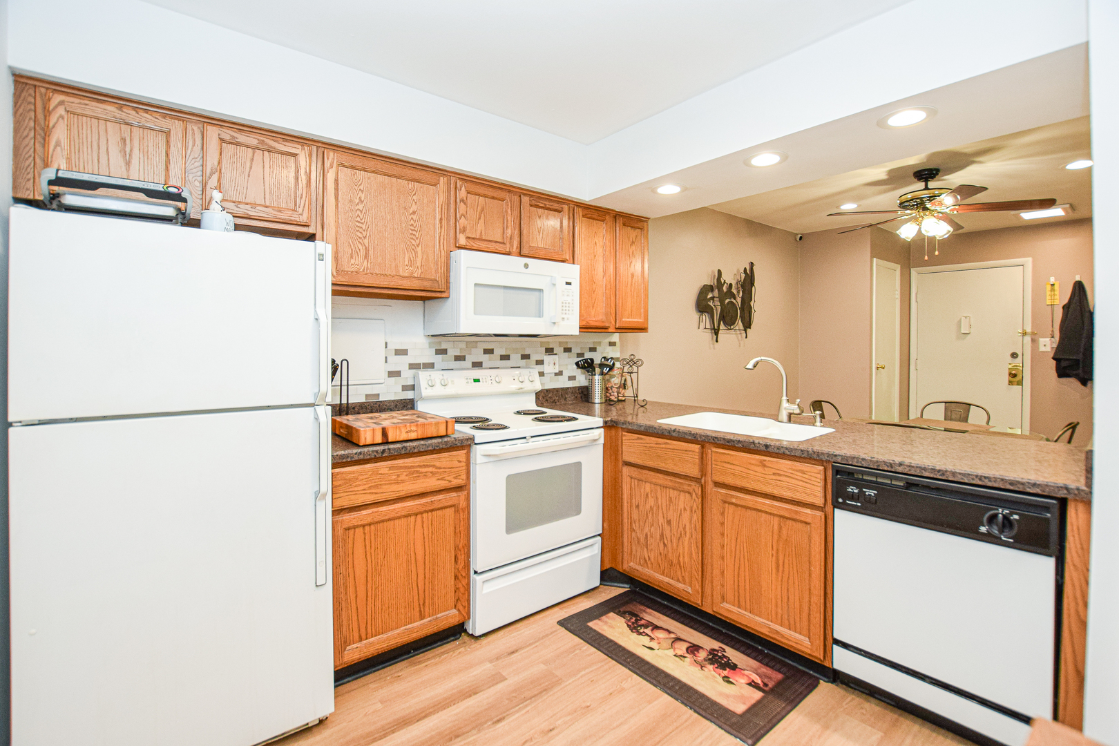 1802 Plum Grove Road, Unit 2A Rolling Meadows, IL 60008 - Photo 8 of 19 a kitchen with a sink a refrigerator and cabinets