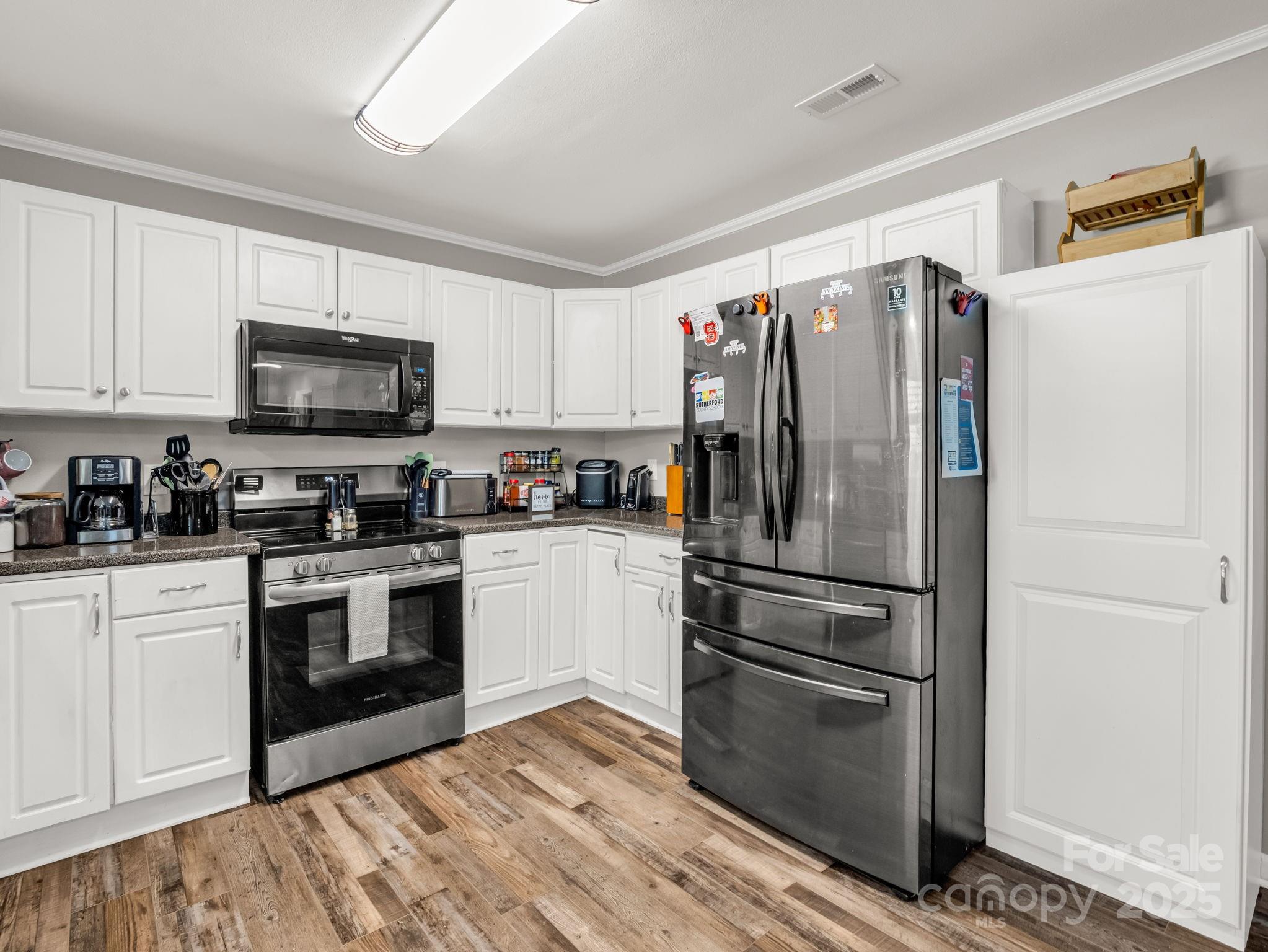 261 Faye Toney Road Mooresboro, NC 28114 - Photo 13 of 48 a kitchen with stainless steel appliances a refrigerator sink and microwave