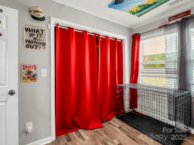a view of a room with a window and wooden floor