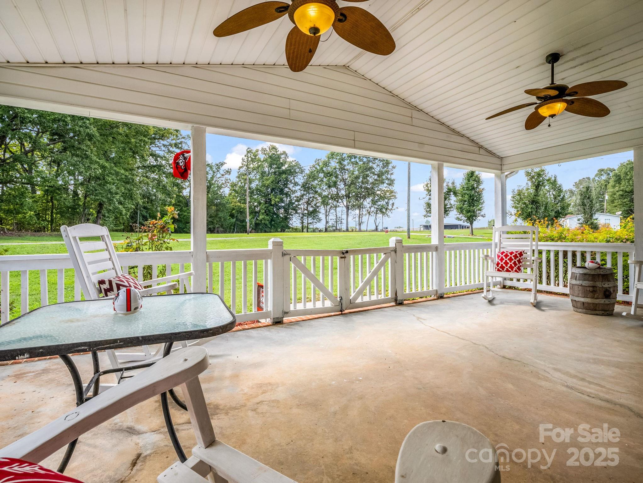 261 Faye Toney Road Mooresboro, NC 28114 - Photo 26 of 48 a view of a patio with a table chairs and a floor to ceiling window