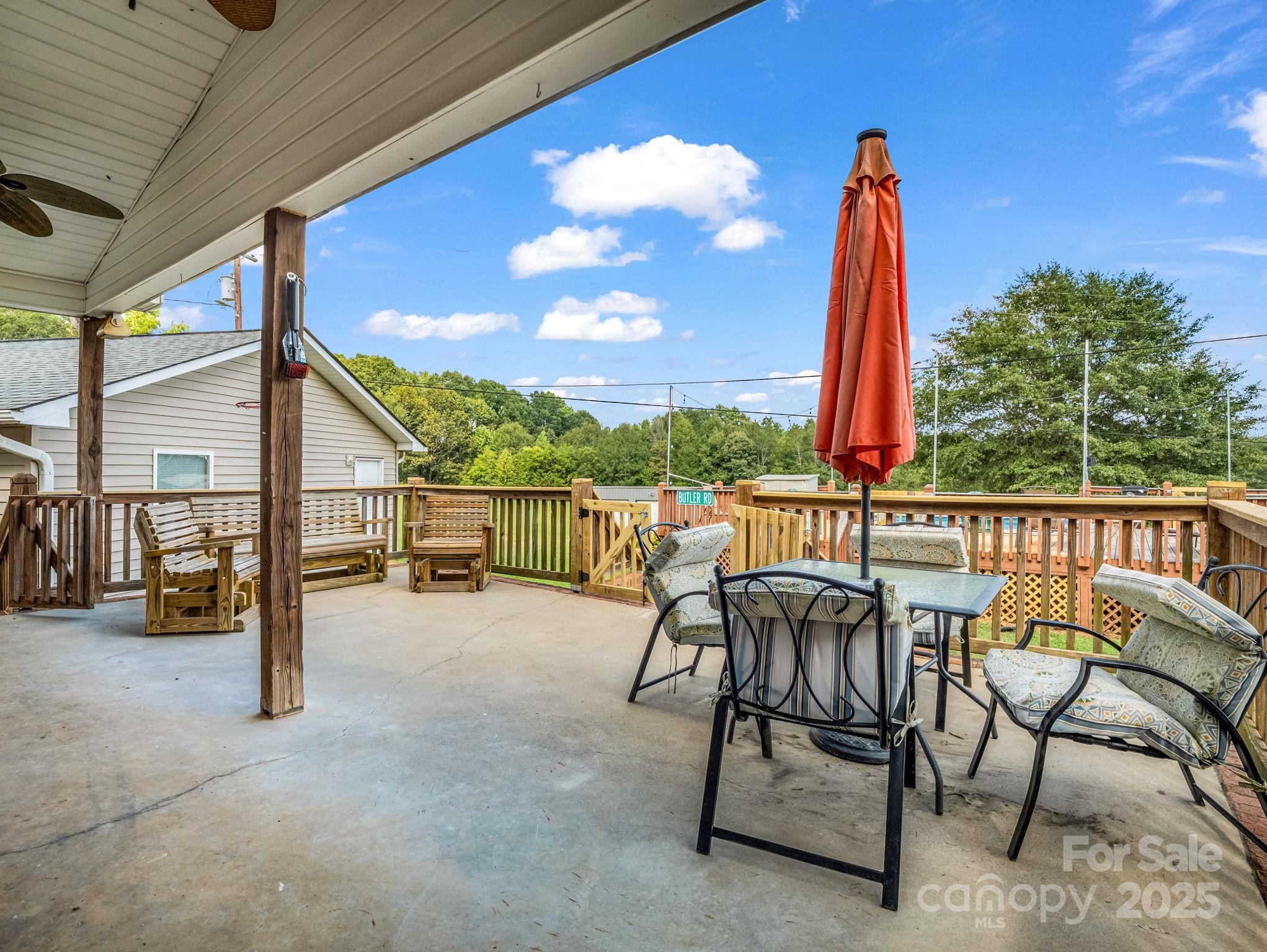 261 Faye Toney Road Mooresboro, NC 28114 - Photo 30 of 48 a view of a patio with a table chairs and a patio