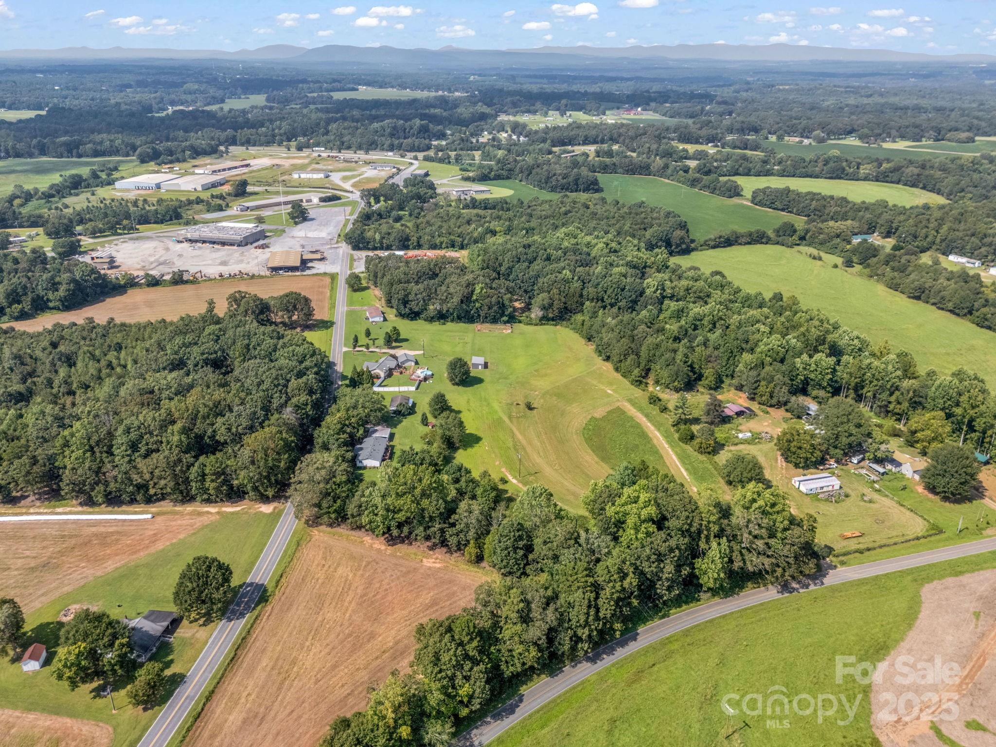 261 Faye Toney Road Mooresboro, NC 28114 - Photo 39 of 48 an aerial view of residential houses with outdoor space and trees