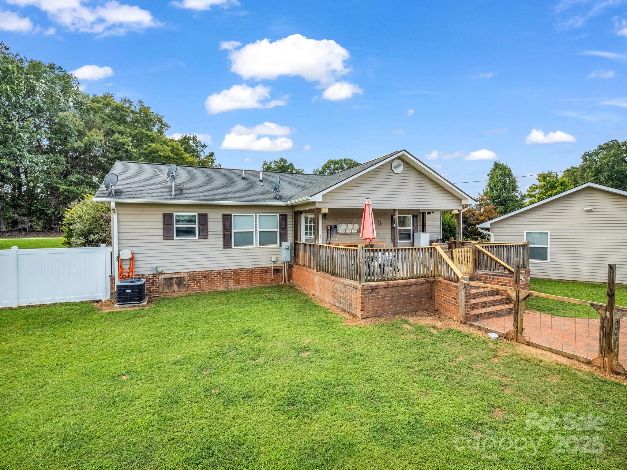 261 Faye Toney Road Mooresboro, NC 28114 - Photo 4 of 48 a front view of a house with a yard and porch