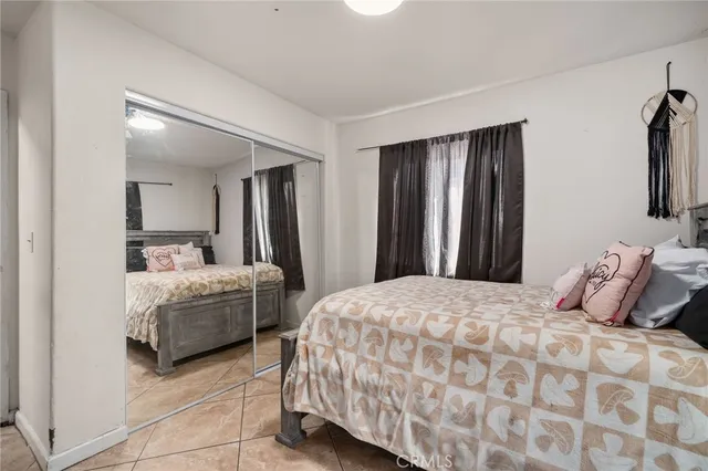 a bedroom with a bed and a mirror