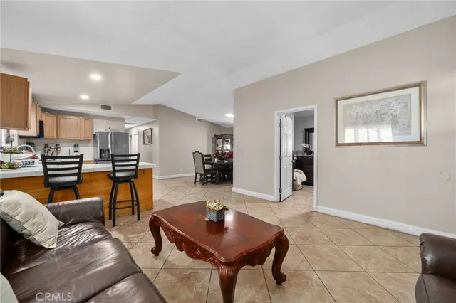 a living room with furniture and kitchen view