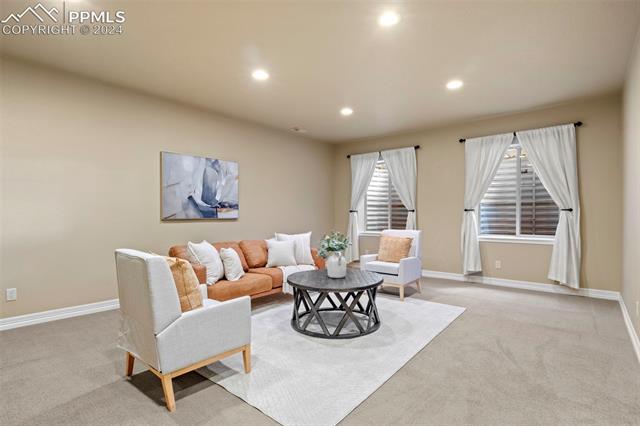 2464 Cinnabar Road Colorado Springs, CO 80921 - Photo 23 of 43 Basement Living room with light colored carpet
