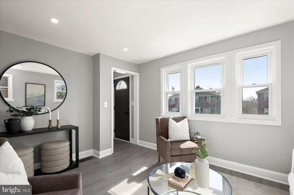 a living room with furniture and a mirror