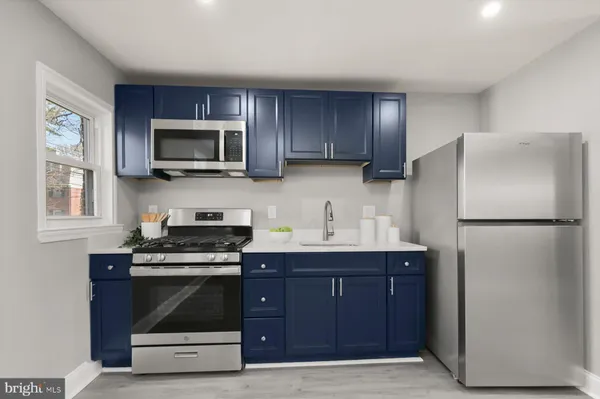 a kitchen with a refrigerator stove and microwave