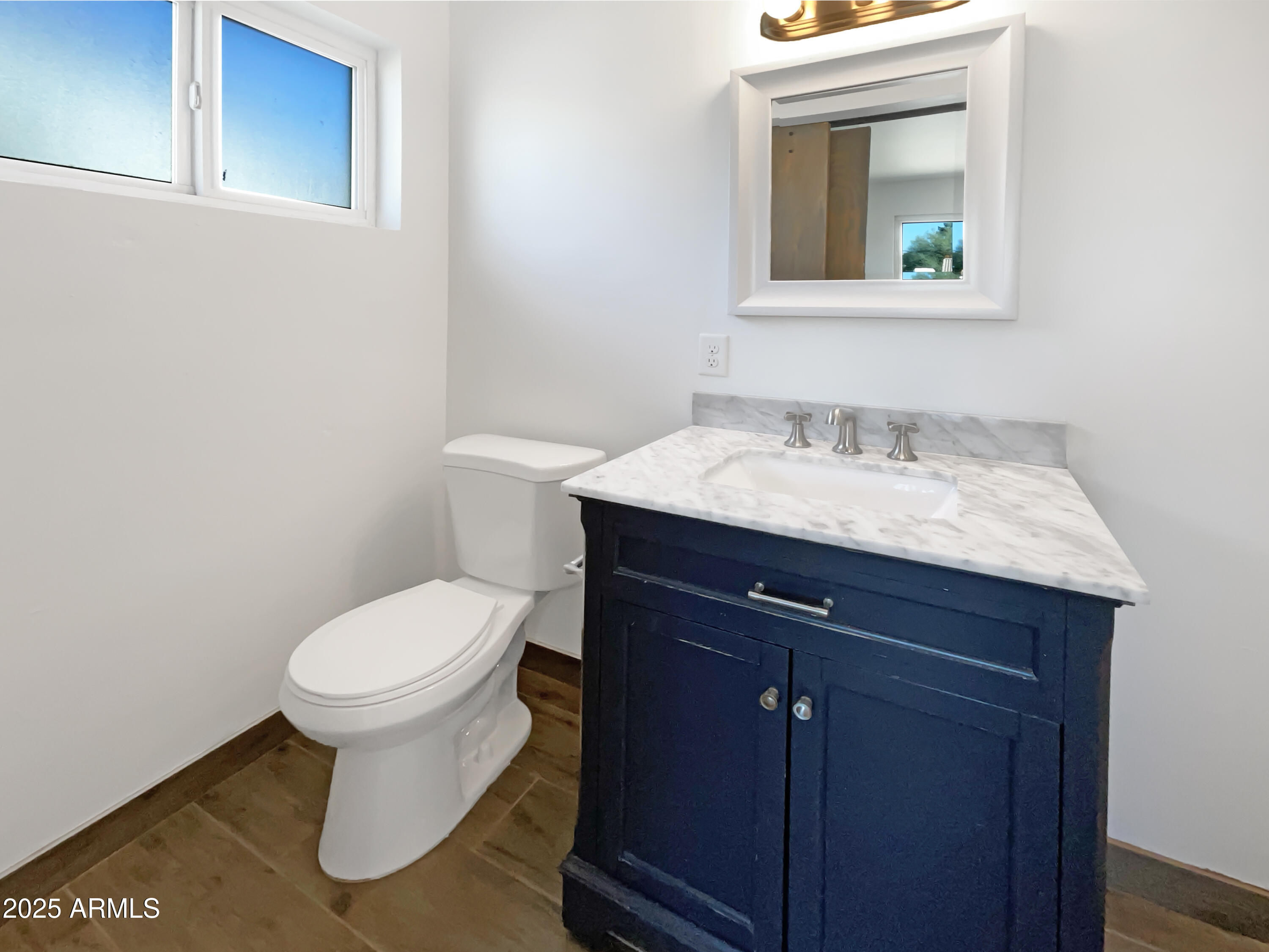 7231 North 23rd Avenue Phoenix, AZ 85021 - Photo 18 of 28 a bathroom with a toilet sink and mirror