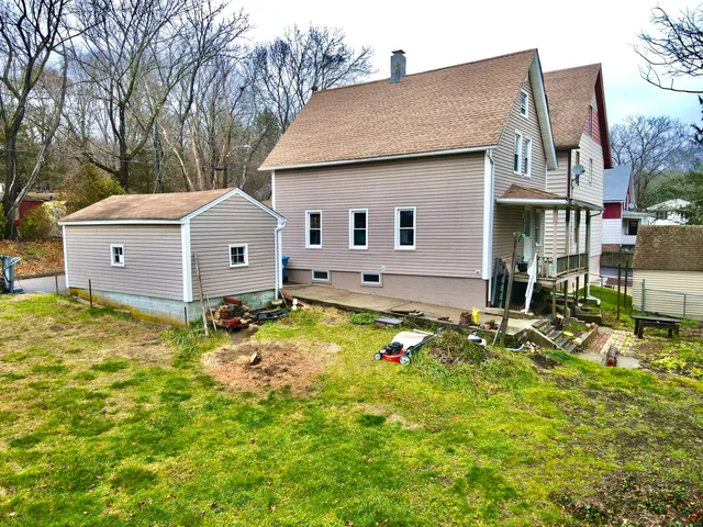 a view of a house with sitting area and large windows