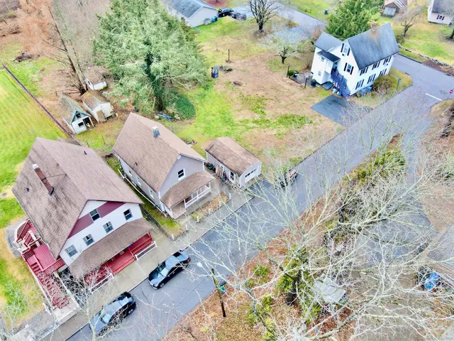 an aerial view of a house with a yard and trees