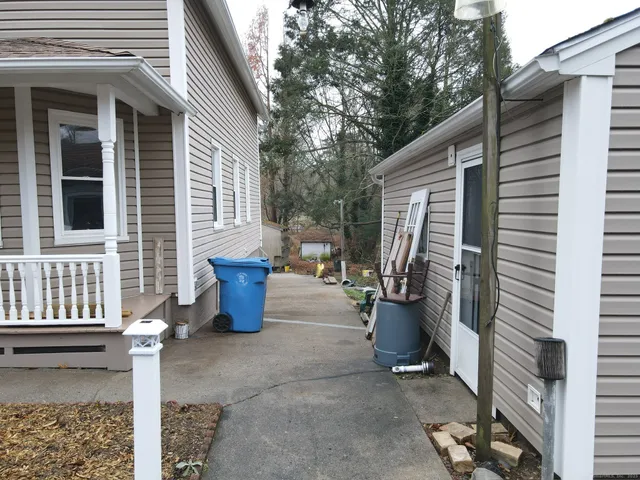 a view of a patio with chairs and plants