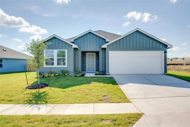 a view of backyard of house along with wooden floor and fence