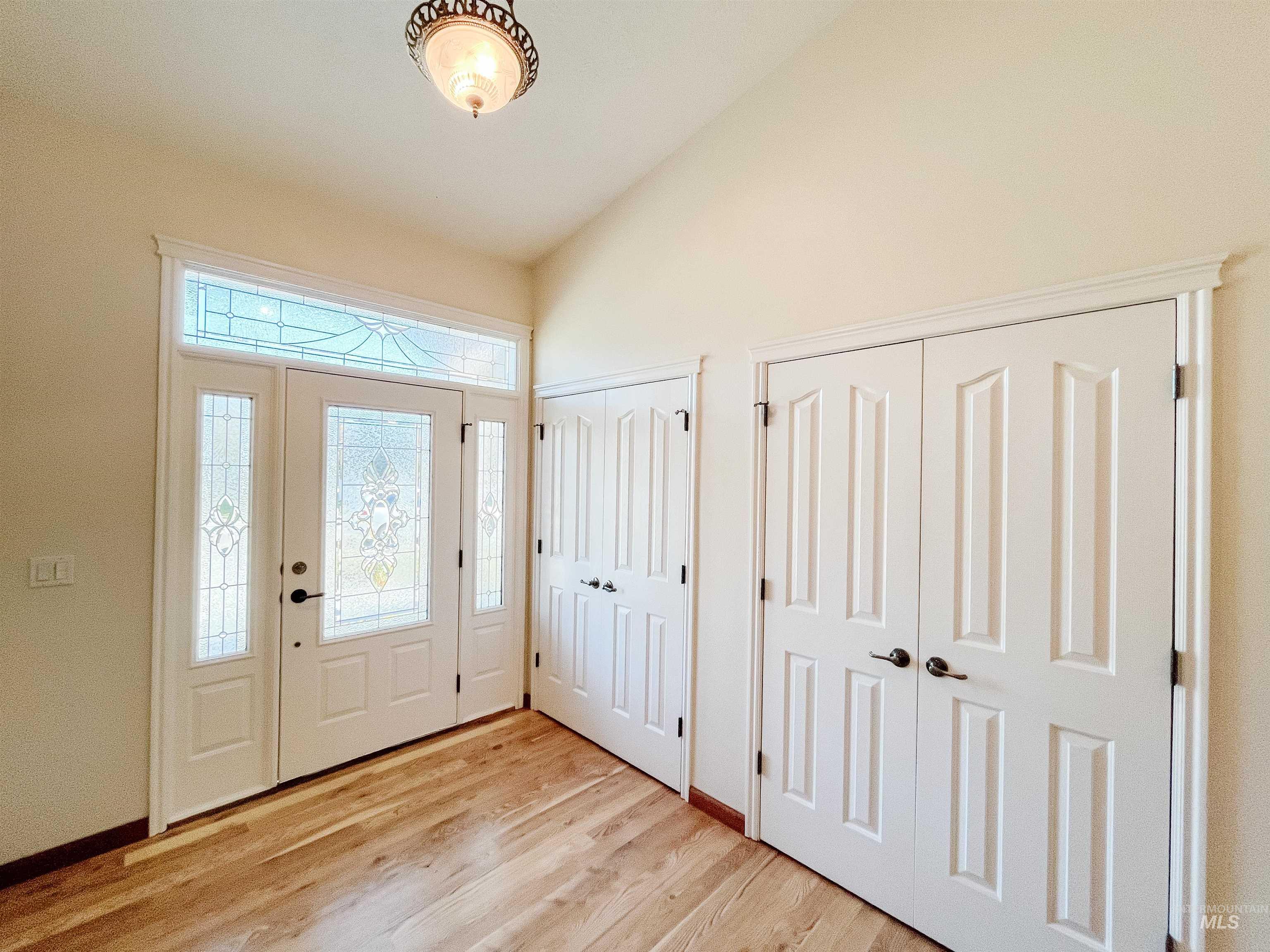 5231 North Morninggale Way Boise, ID 83713 - Photo 2 of 44 Foyer entrance featuring lofted ceiling and light wood-style floors