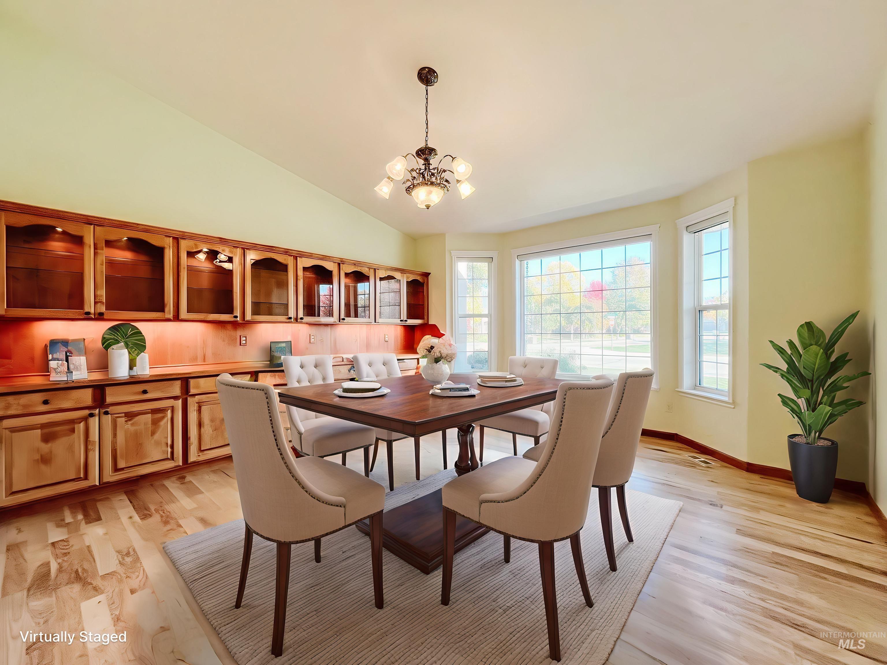 5231 North Morninggale Way Boise, ID 83713 - Photo 21 of 44 Dining area with light wood finished floors, a chandelier, and lofted ceiling