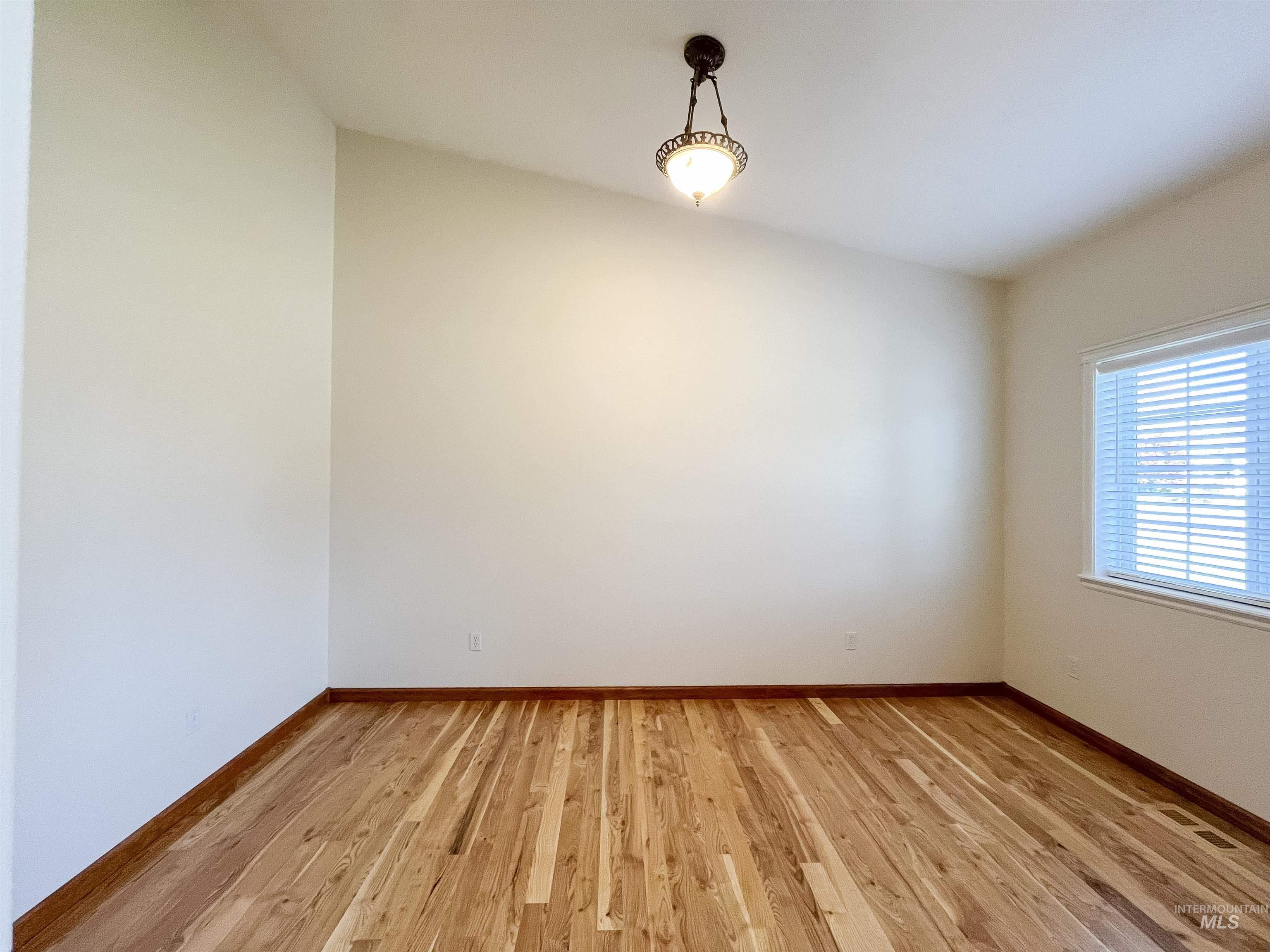 5231 North Morninggale Way Boise, ID 83713 - Photo 6 of 44 Spare room featuring light wood-type flooring and baseboards