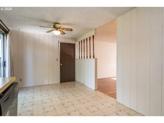 a view of a hallway with a chandelier fan