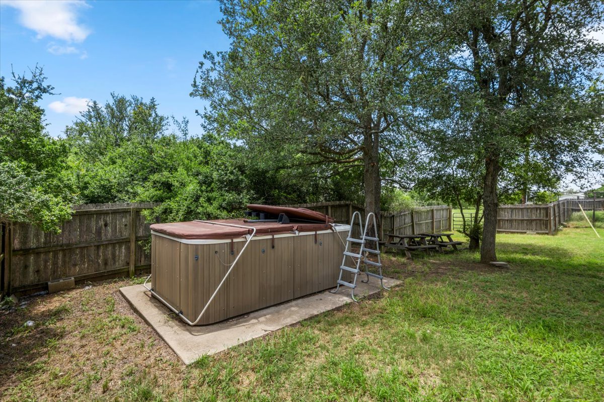 437 Balch Road Elgin, TX 78621 - Photo 27 of 37 Relax in the privacy of your own backyard spa/hot tub, surrounded by natural fencing and mature trees.
