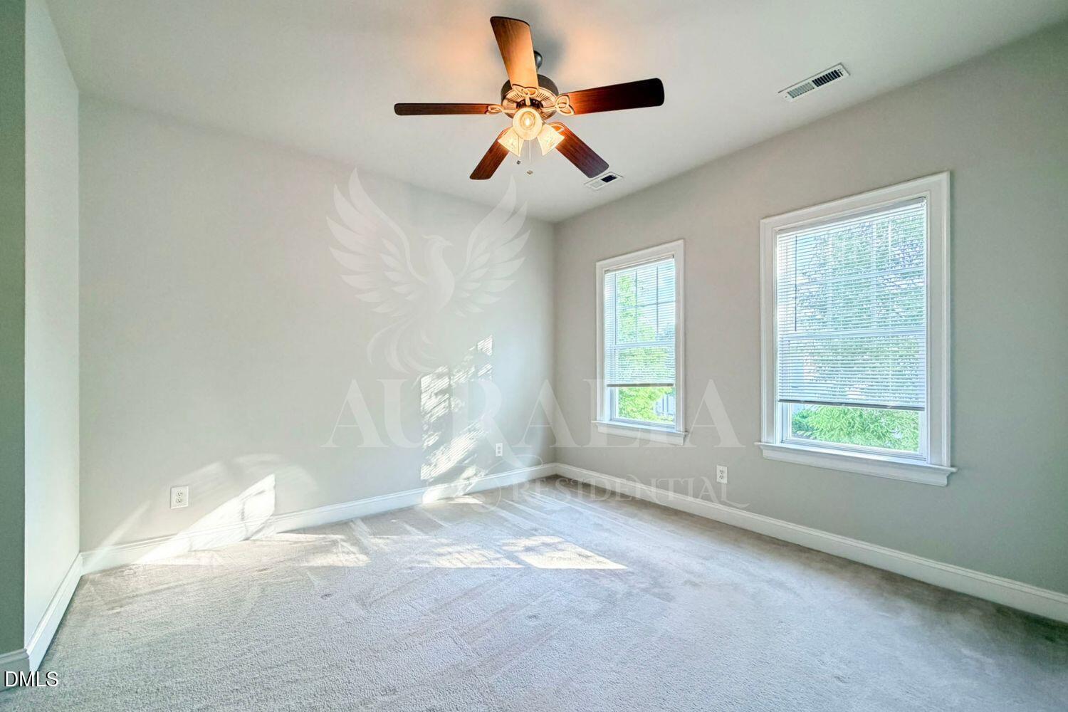 7754 ACC Boulevard Raleigh, NC 27617 - Photo 28 of 41 an empty room with windows and fan