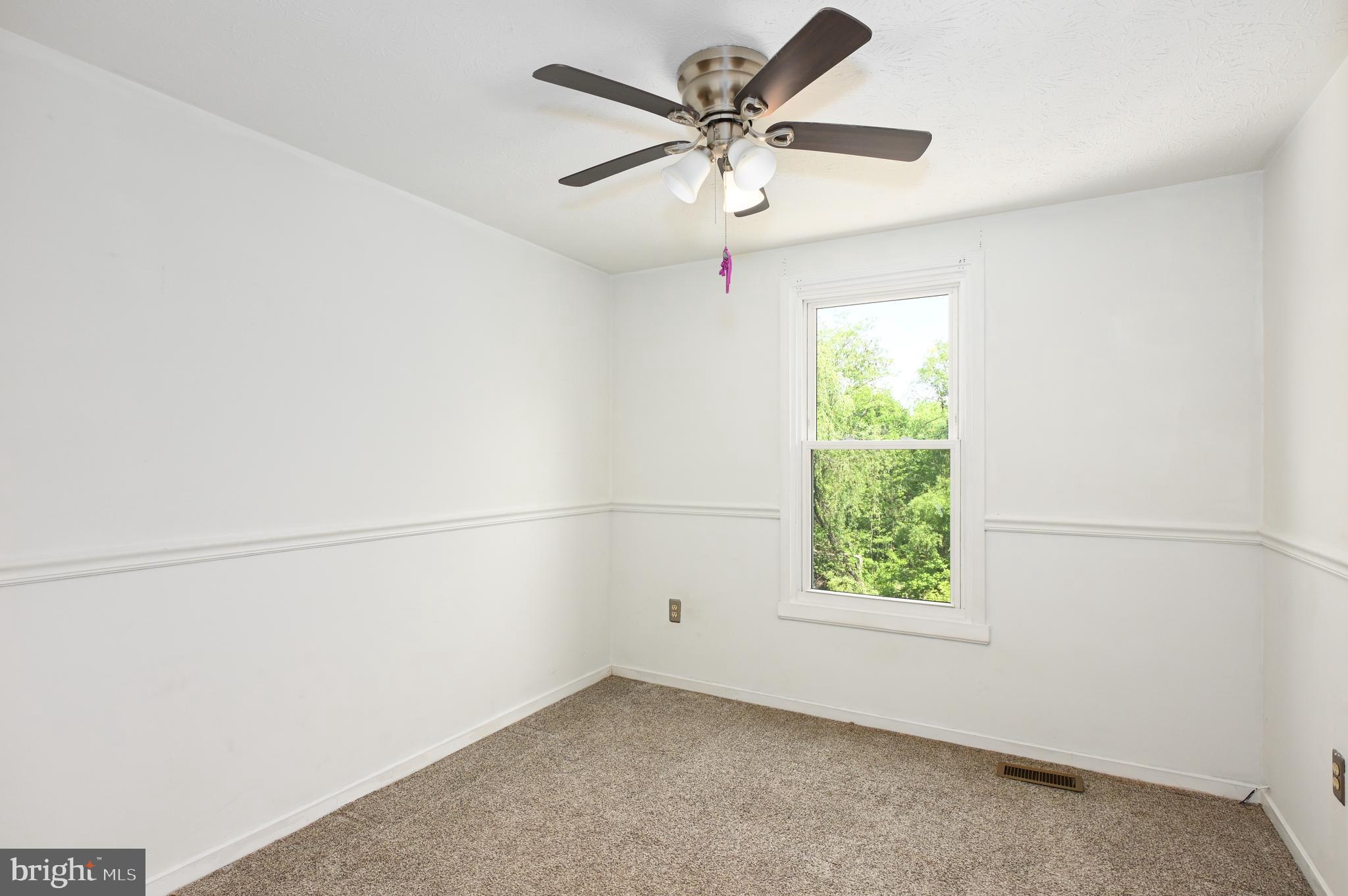 22 Morning Court Rosedale, MD 21237 - Photo 33 of 42 an empty room with a window and a fan