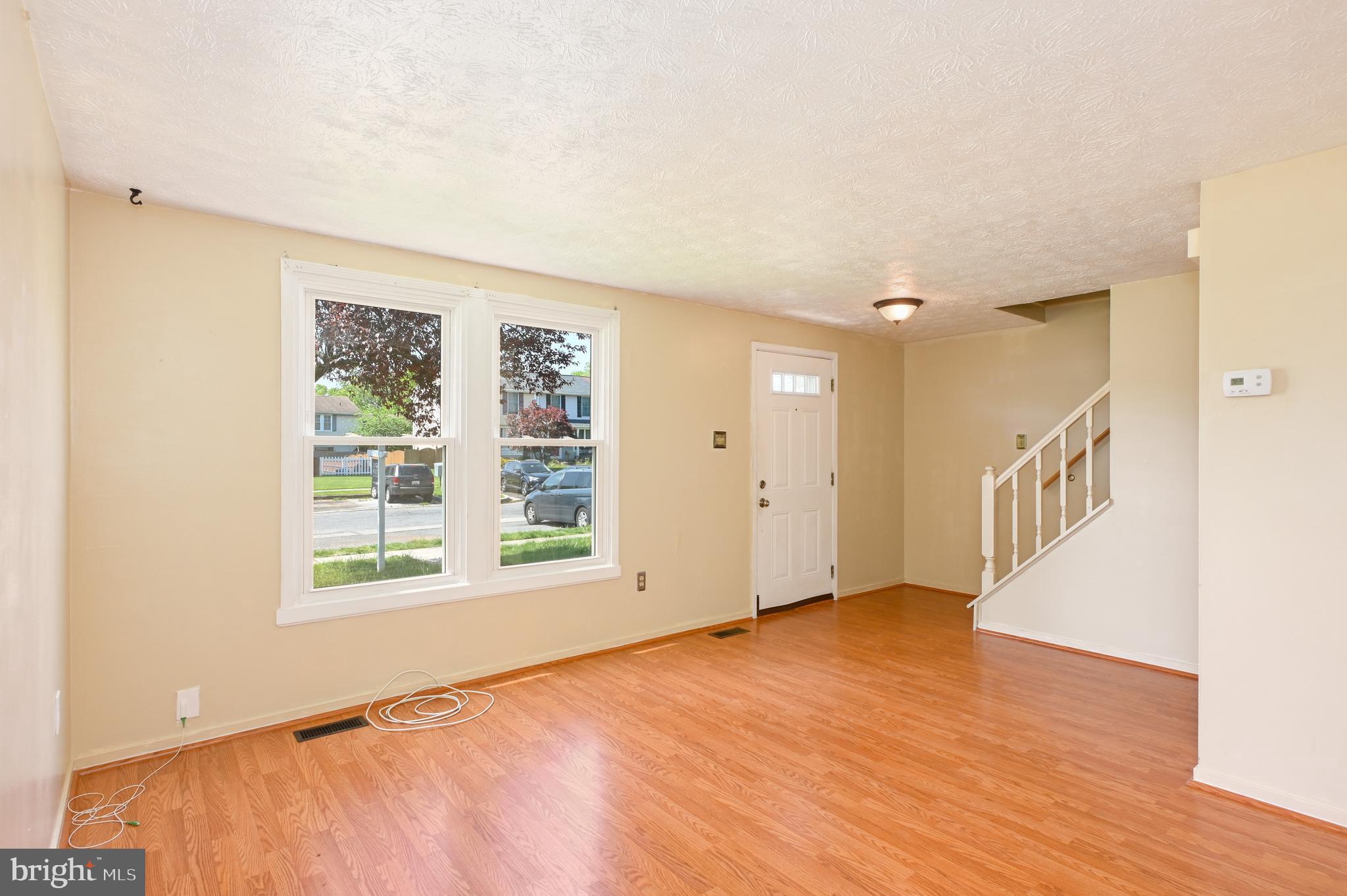 22 Morning Court Rosedale, MD 21237 - Photo 5 of 42 a view of an empty room with wooden floor and a window
