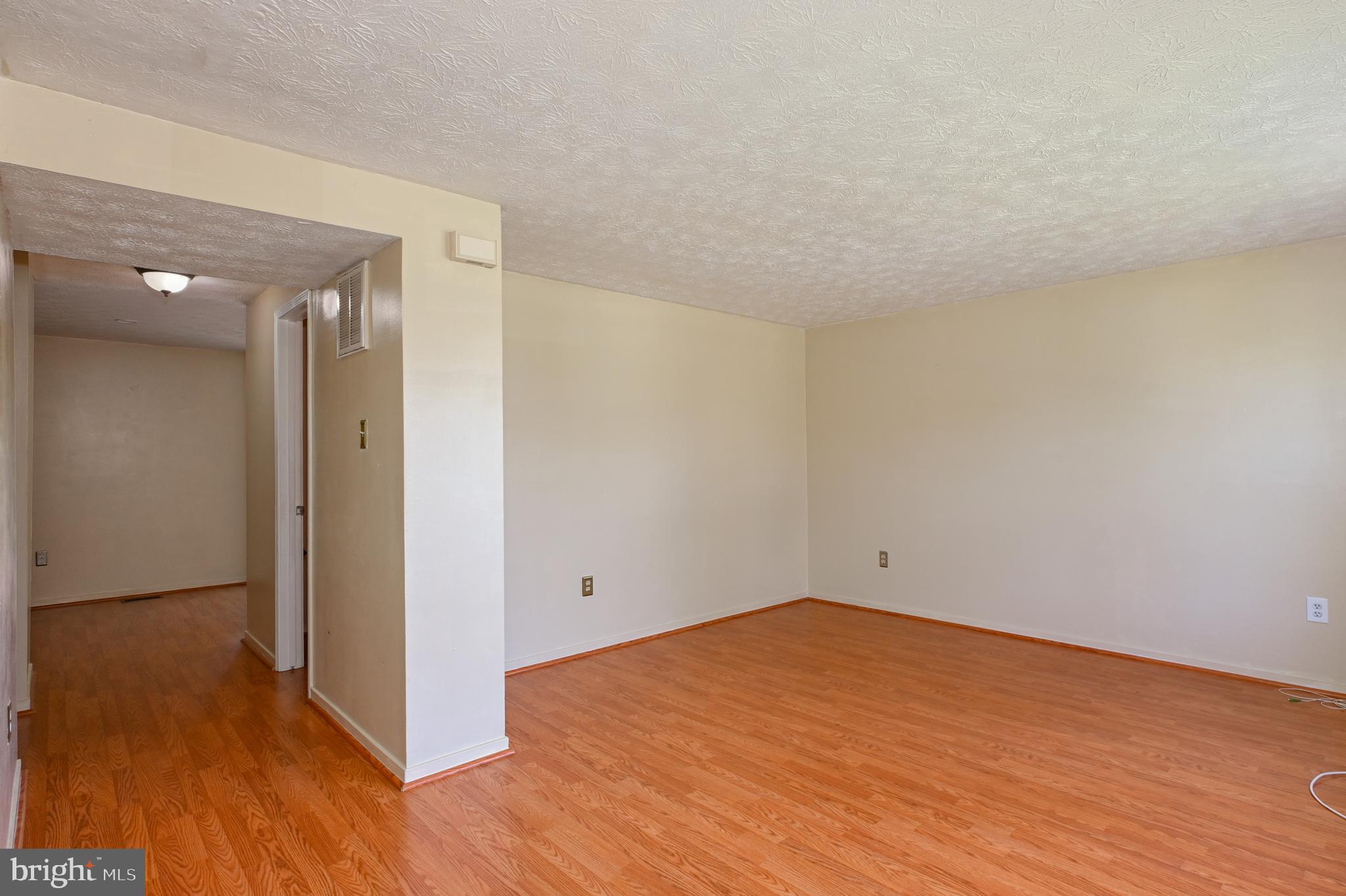 22 Morning Court Rosedale, MD 21237 - Photo 7 of 42 a view of empty room with wooden floor