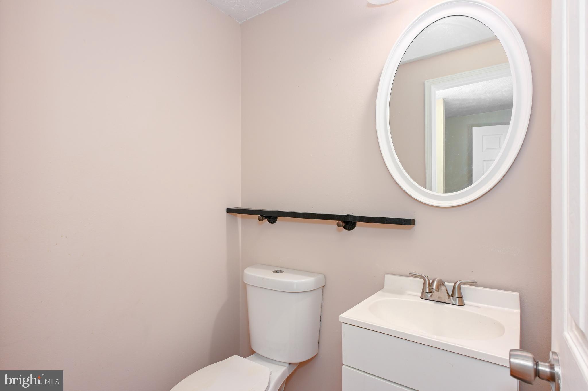 22 Morning Court Rosedale, MD 21237 - Photo 8 of 42 a bathroom with a toilet sink and mirror