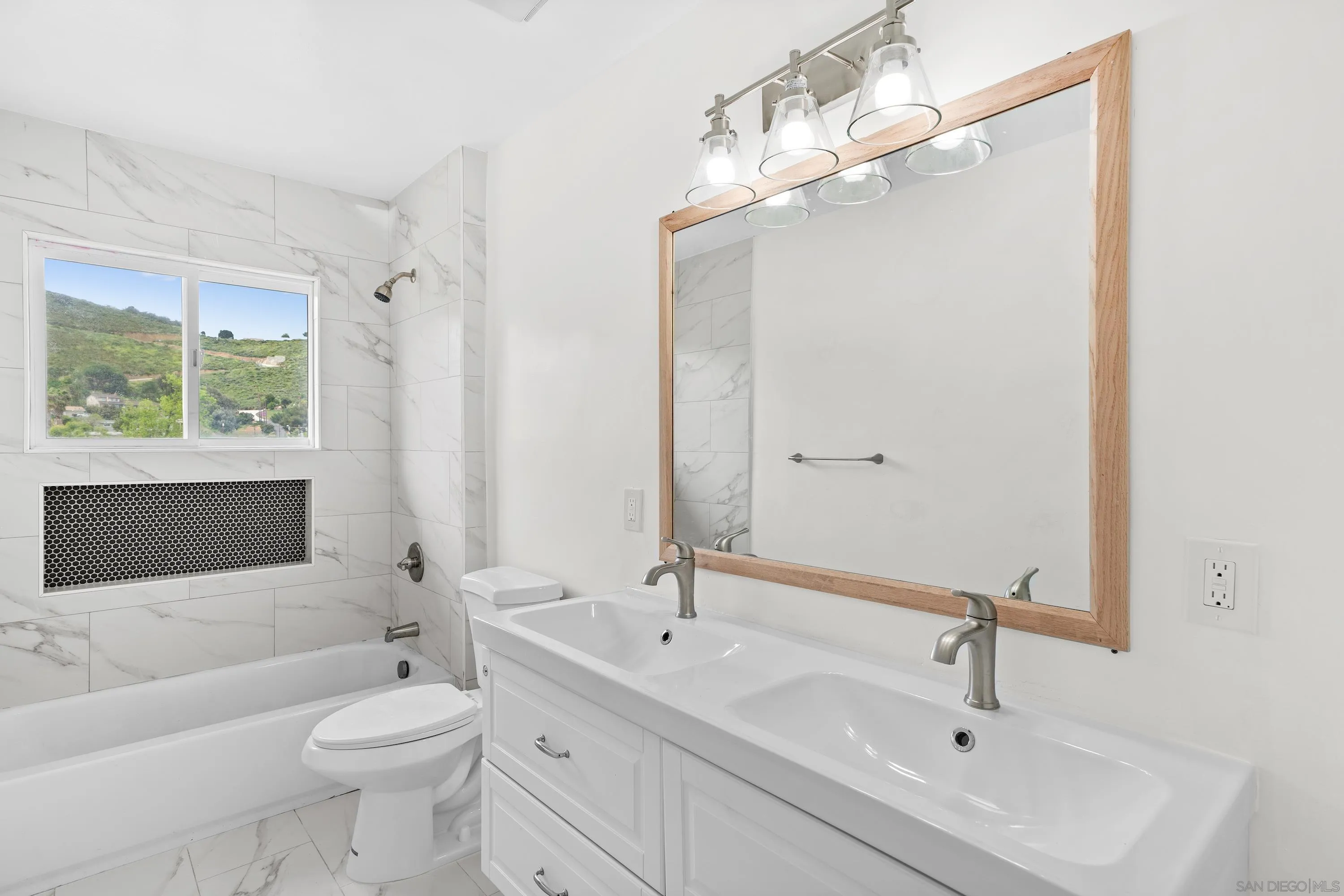 8612 Almond Road Lakeside, CA 92040 - Photo 12 of 30 a bathroom with a toilet a sink a mirror a bathtub and shower