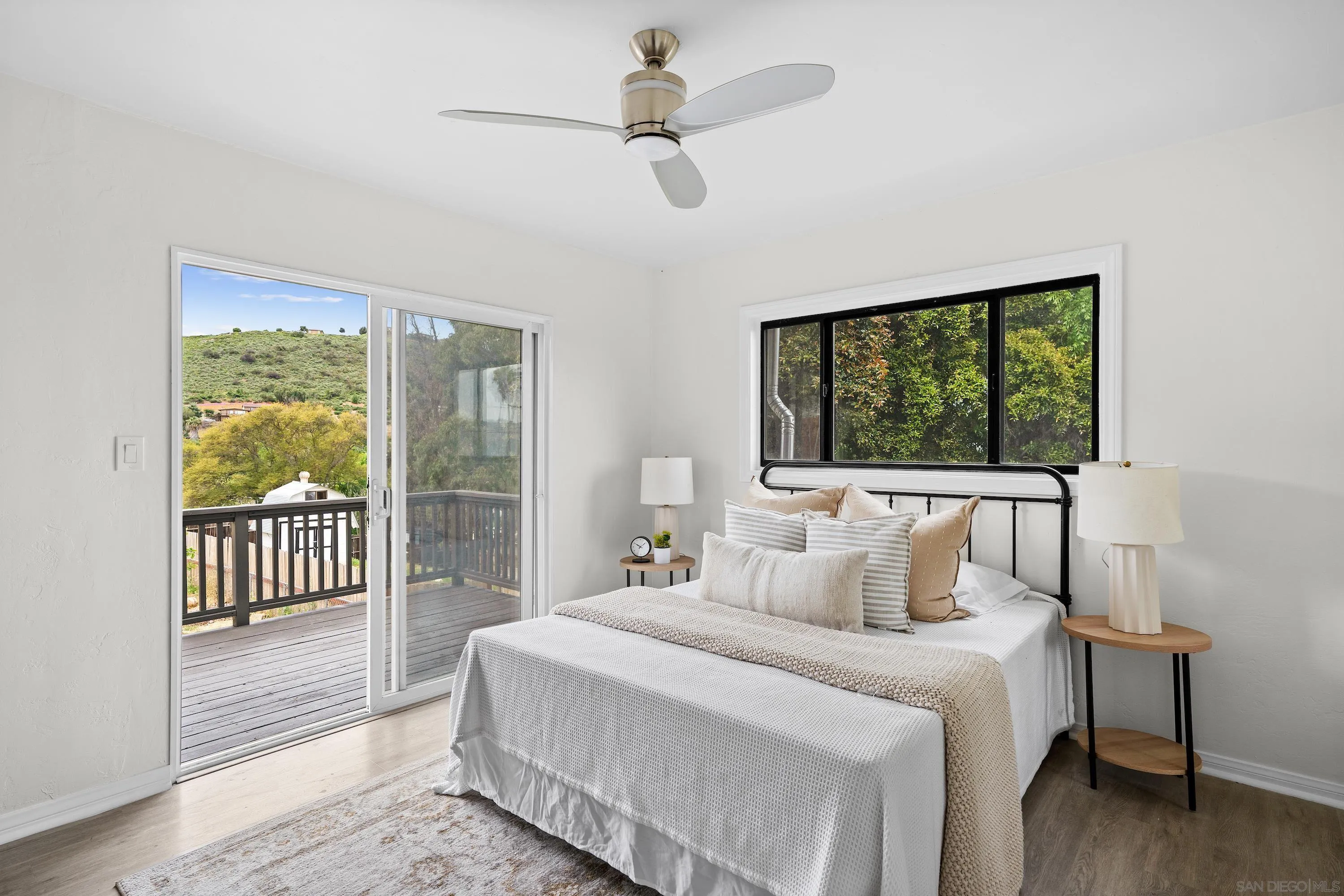 8612 Almond Road Lakeside, CA 92040 - Photo 16 of 30 a bedroom with a large bed and a chandelier fan
