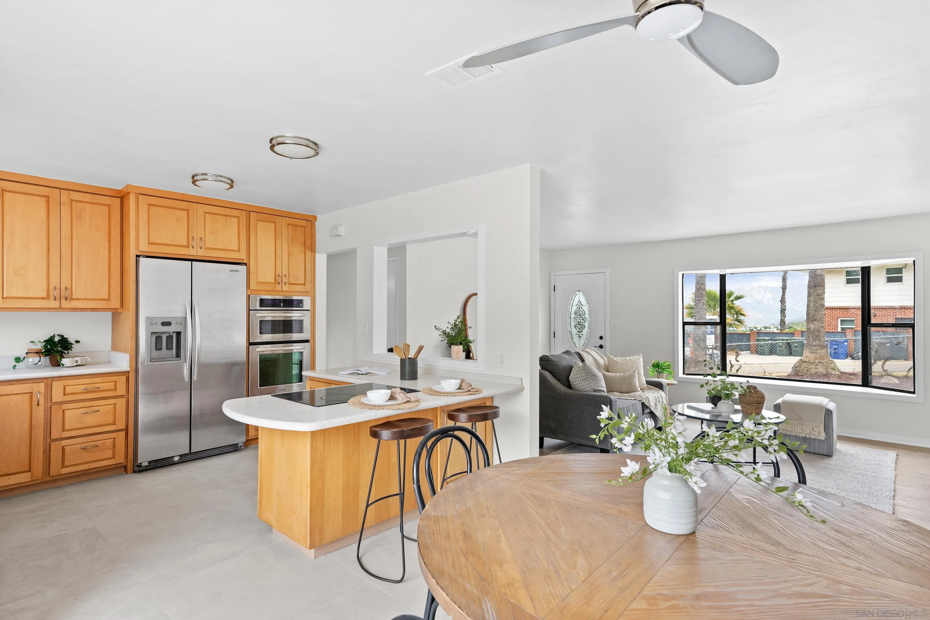 8612 Almond Road Lakeside, CA 92040 - Photo 21 of 30 a dining room with stainless steel appliances furniture a couch and a large window
