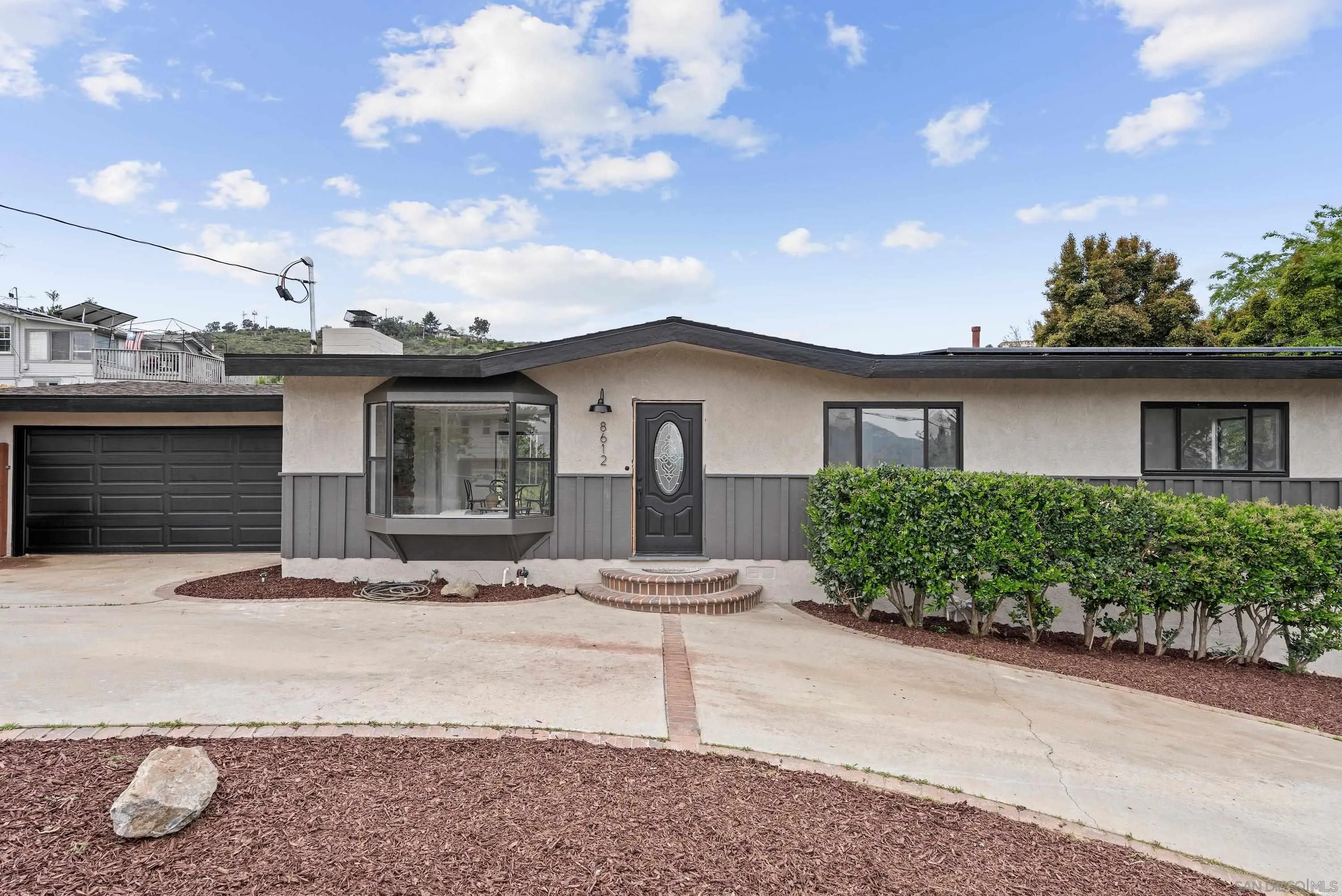 8612 Almond Road Lakeside, CA 92040 - Photo 3 of 30 a white house with a yard and plants