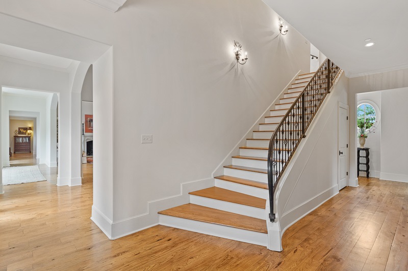 272 Dubray Manor Drive Collierville, TN 38017 - Photo 18 of 25 2 sweeping staircases each on opposite ends of light filled hallway & 3 upstairs suites.