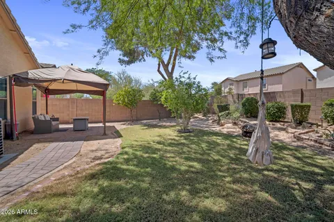 a patio with a table and chairs under an umbrella