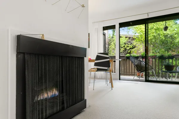 a living room with furniture and a book shelf