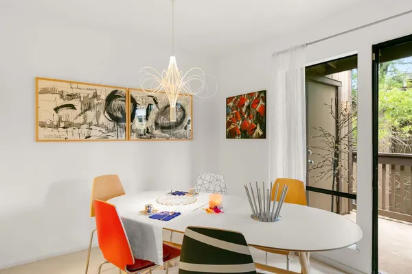 a dining room with furniture and wooden floor