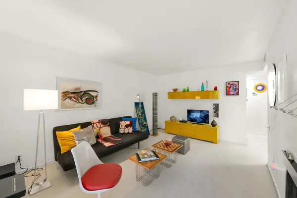 a living room with furniture and a flat screen tv