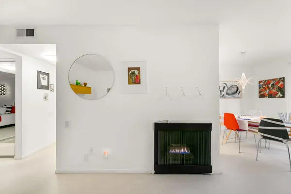 a kitchen with a refrigerator and white cabinets