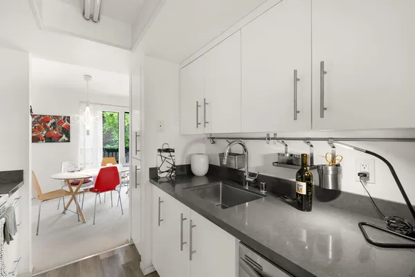 a kitchen with a sink a stove and a microwave