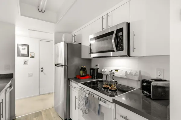 a en suite bathroom with a granite countertop sink toilet and shower