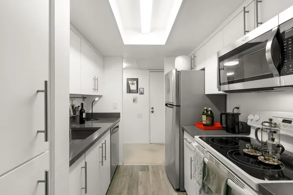 a en suite bathroom with a double vanity sink a mirror and a shower