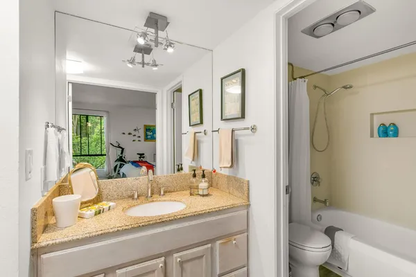 a bedroom with a bed and a refrigerator